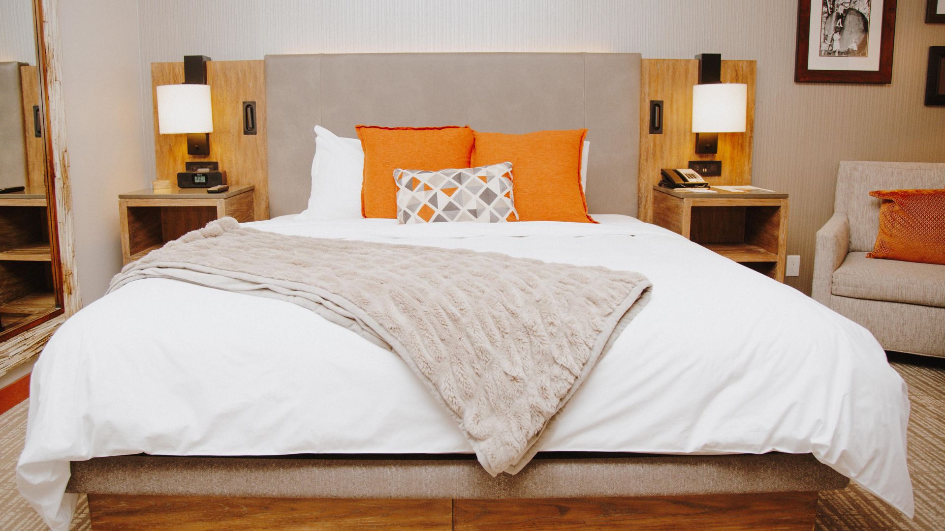 A Bed With Orange And White Sheets