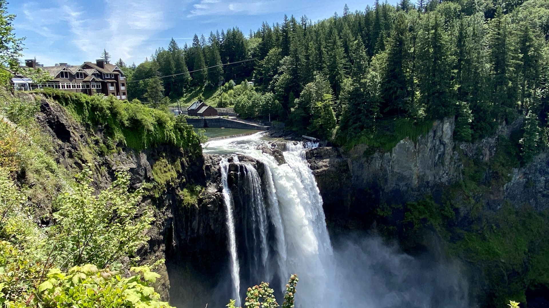 A Large Waterfall In A Forest With Snoqualmie Falls In The Background