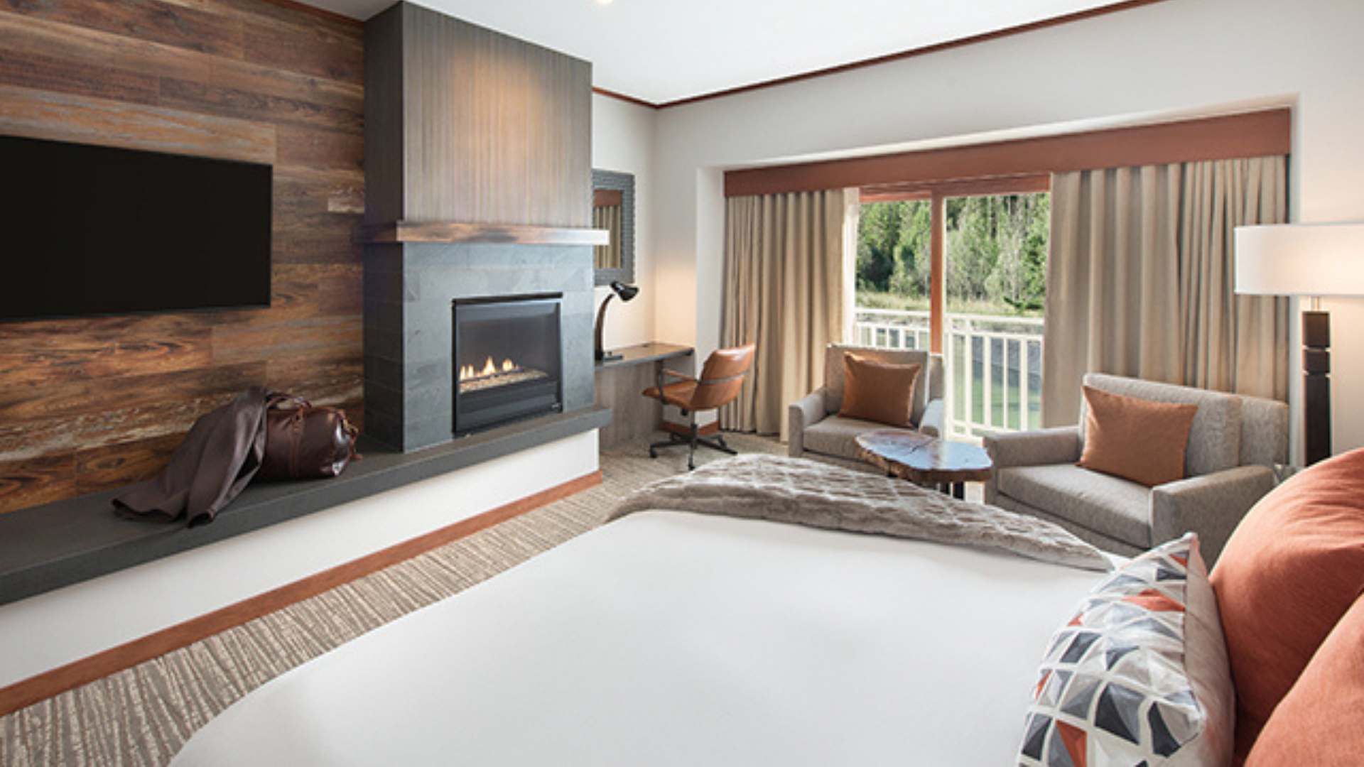 A View Of A Living Room With A Bed And A Fireplace